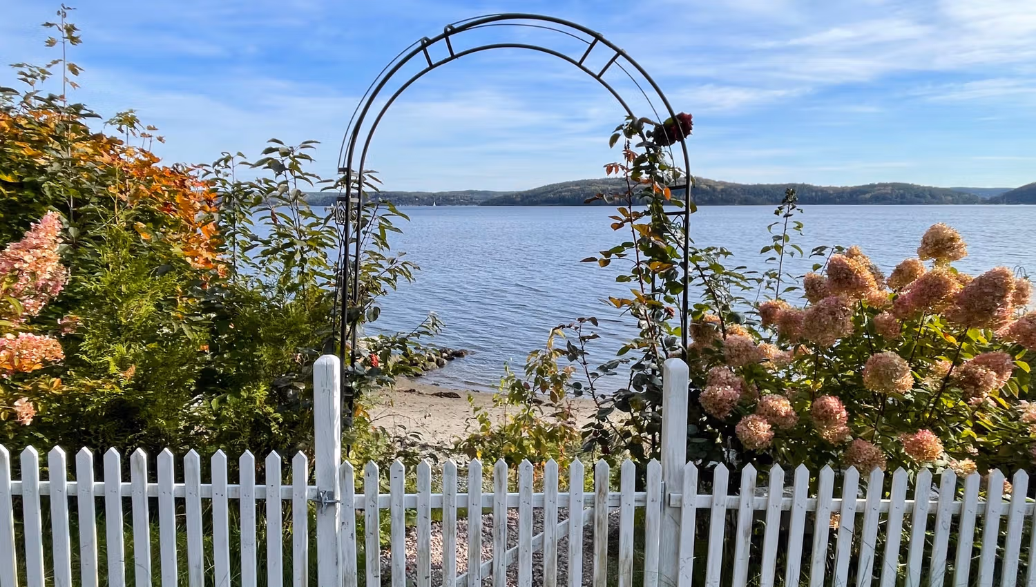 White gate and flowers, sea