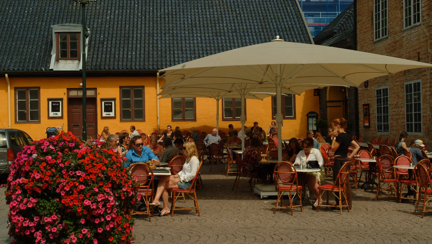 Outdoor seating underneath a parasol.