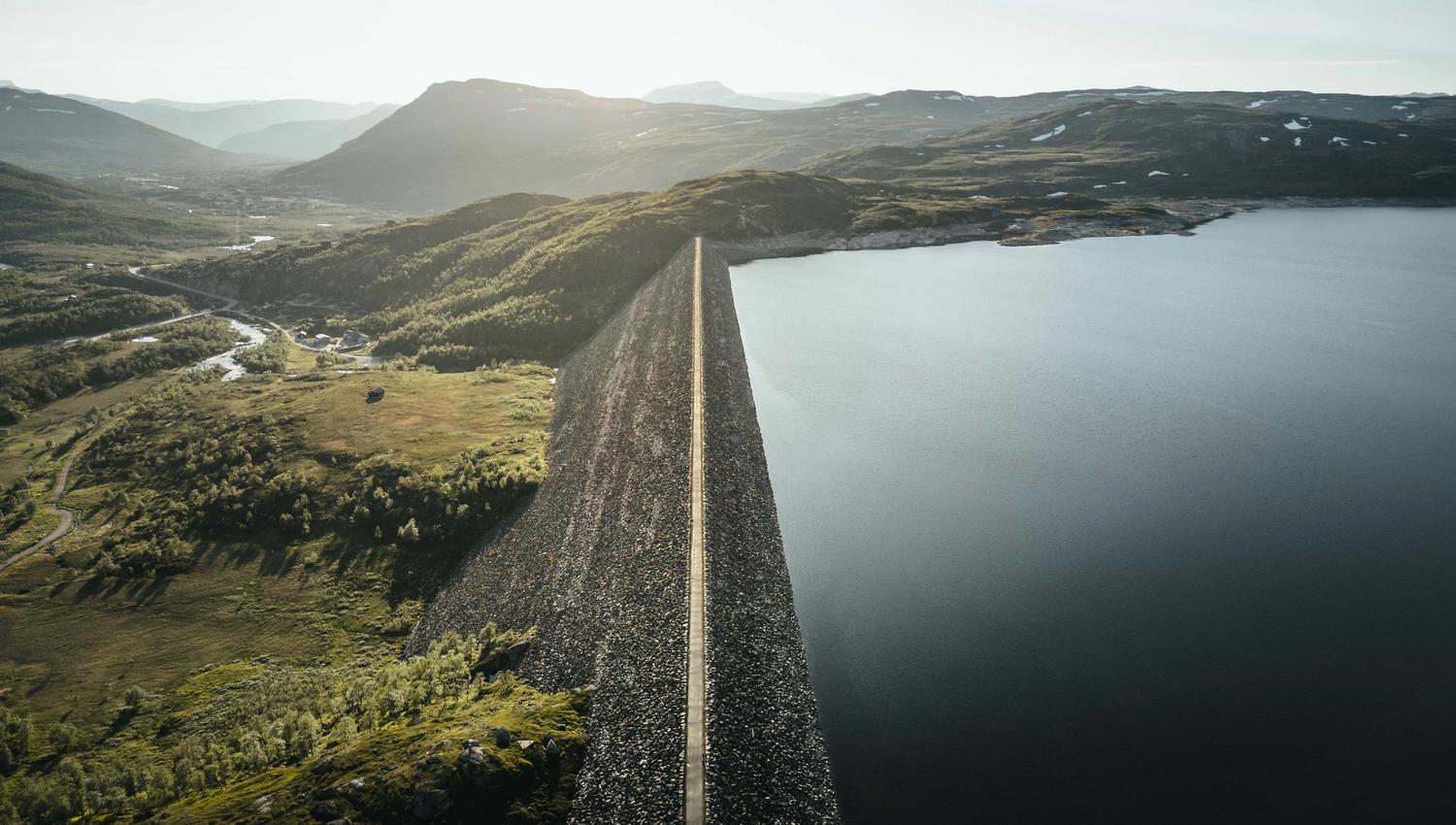 A drone photo of the Sysendammen dam during sunset.