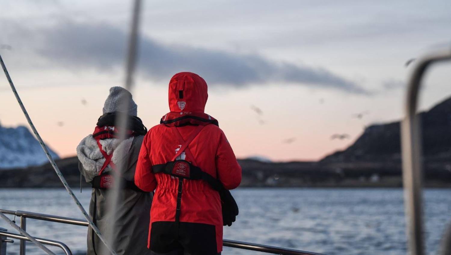 Two people enjoying the view on a sailing boat