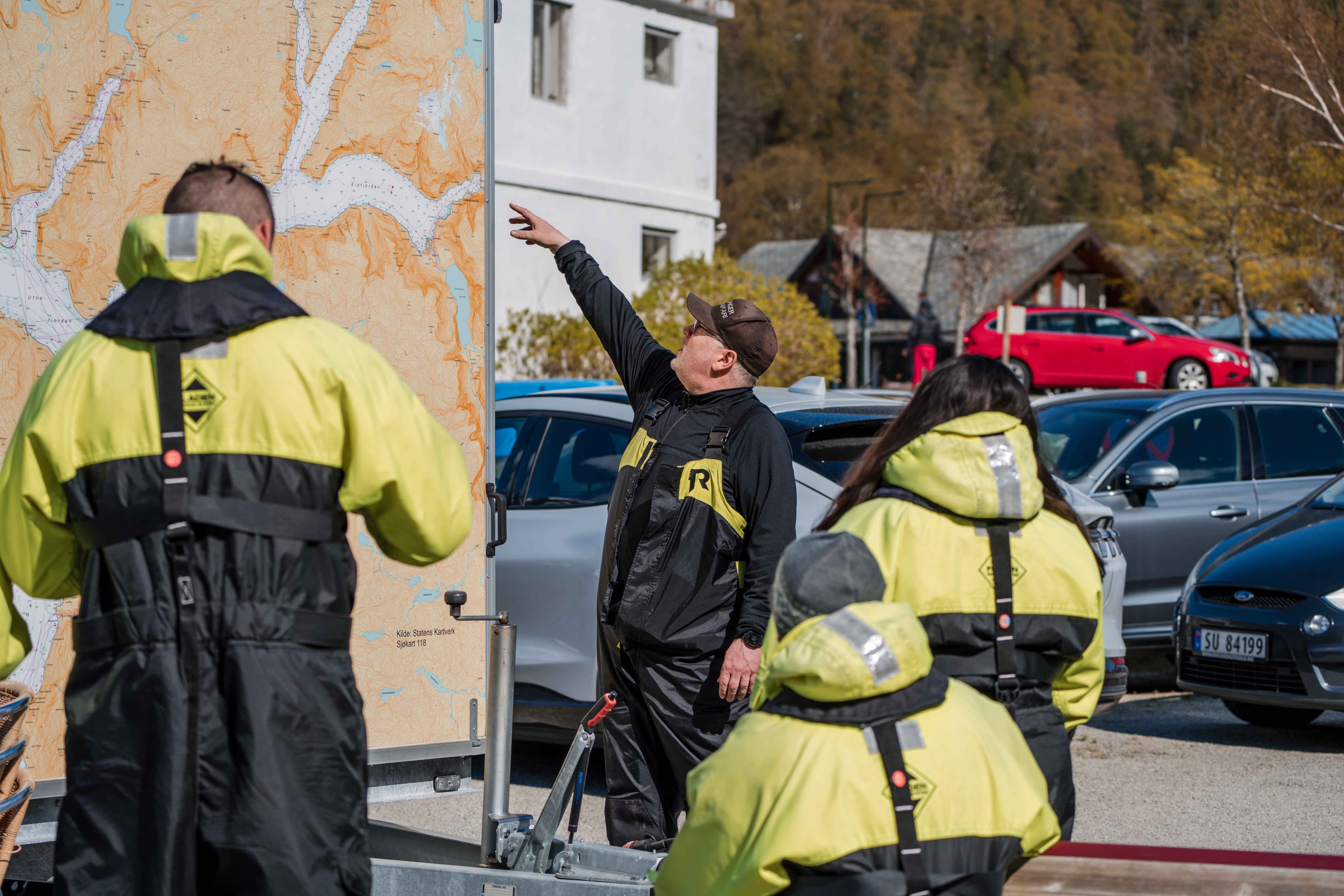The captain is instructing the passengers before the boat trip.