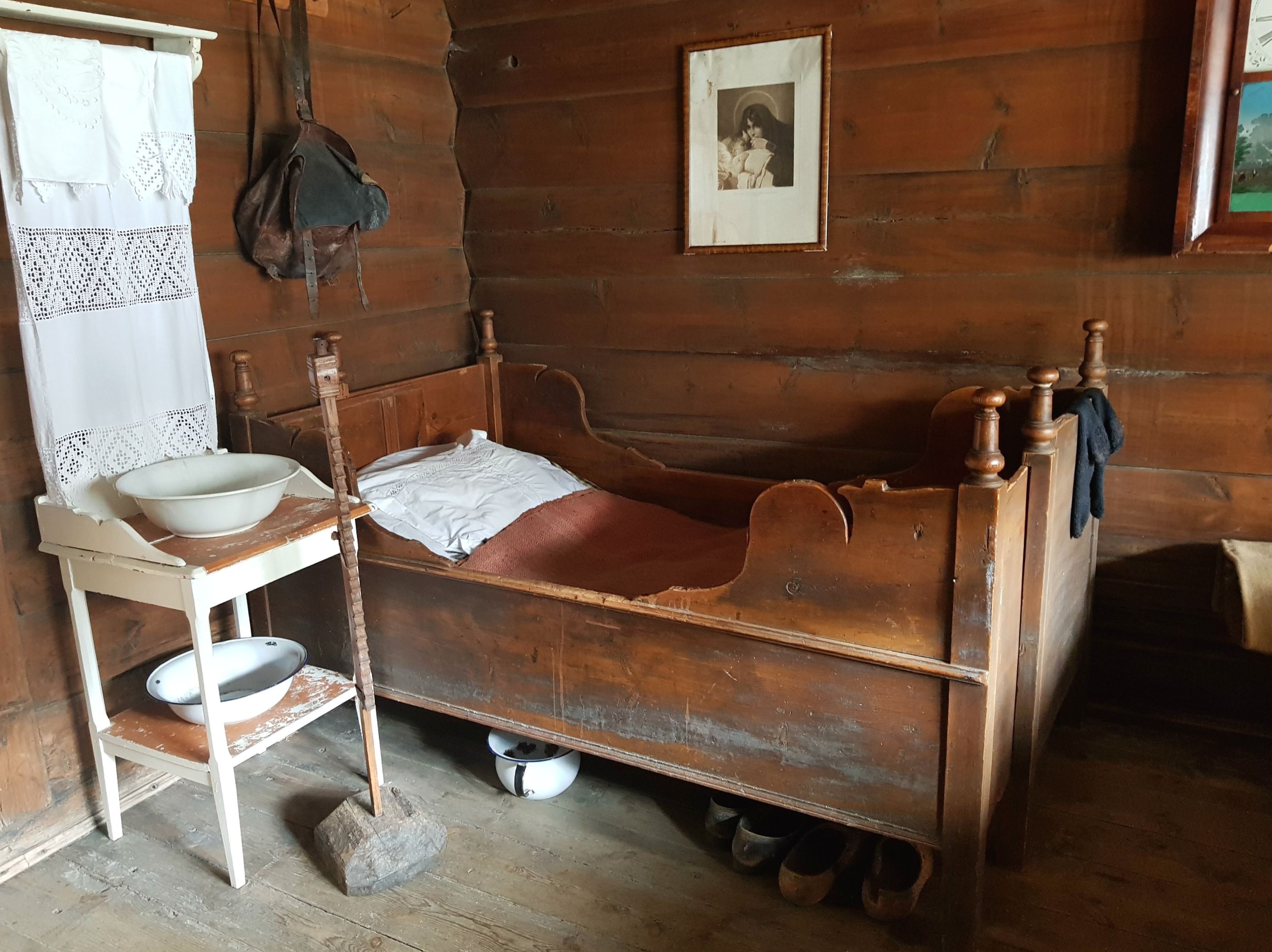 A wooden bed in a bedroom