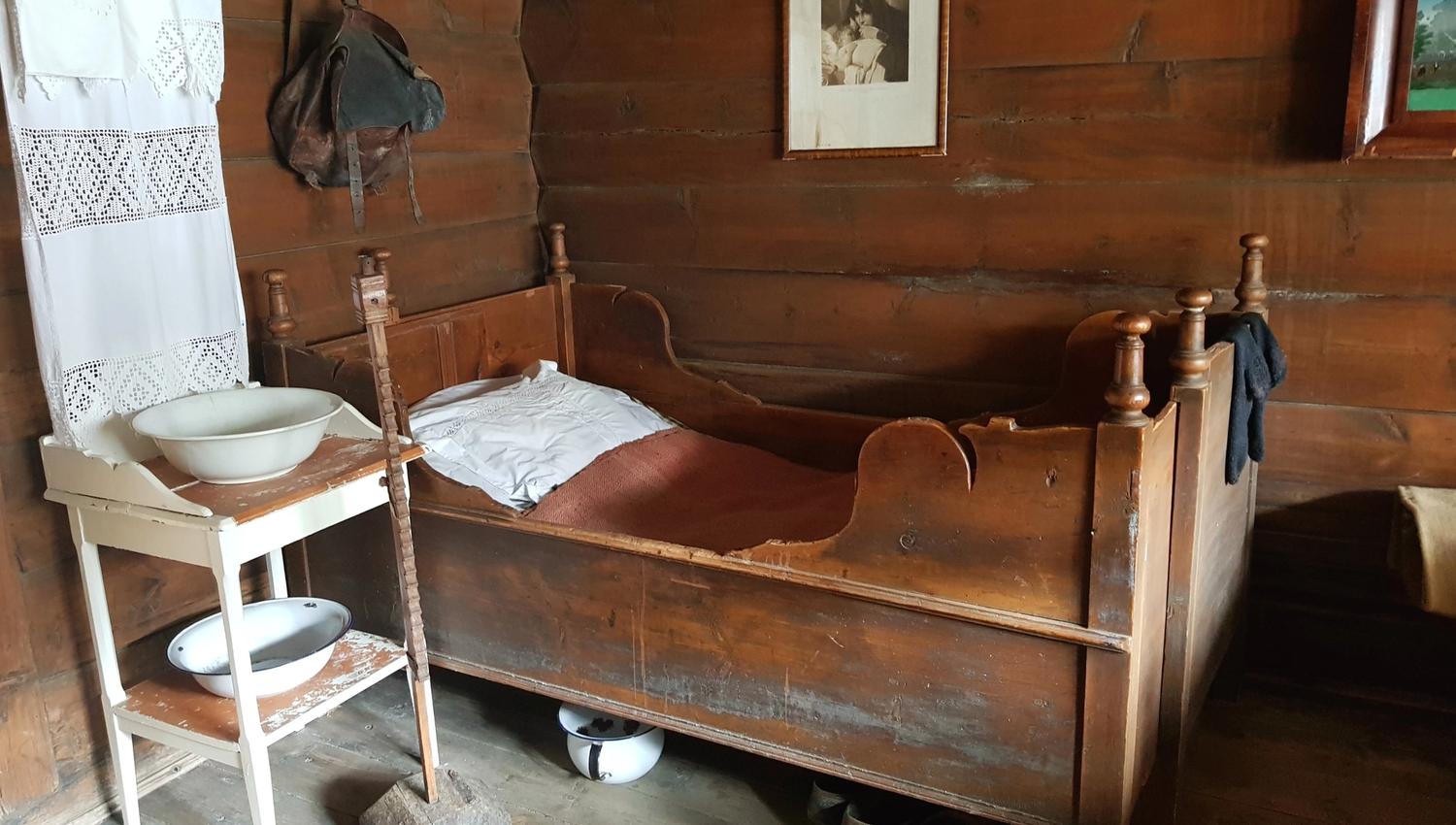 A wooden bed in a bedroom