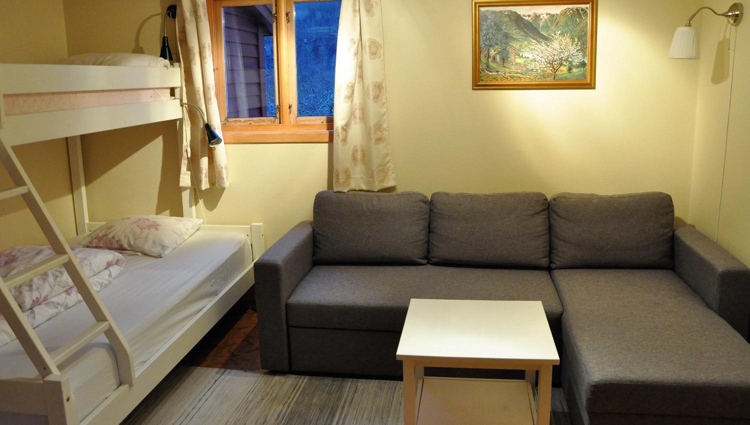 A bunk bed and a sofas in a bed room