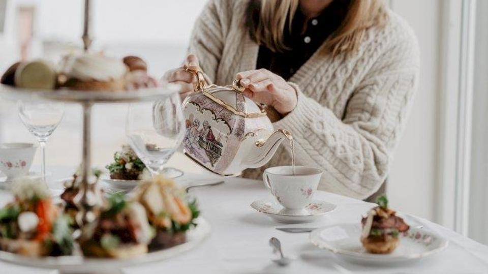 Poster for the event: a picture of someone pouring tea into a teacup.
