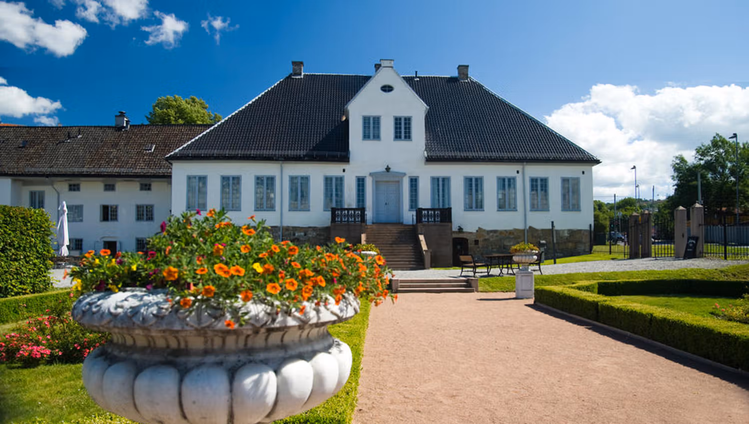 Exterior: White manor from the Baroque era with a lawn in front of it.