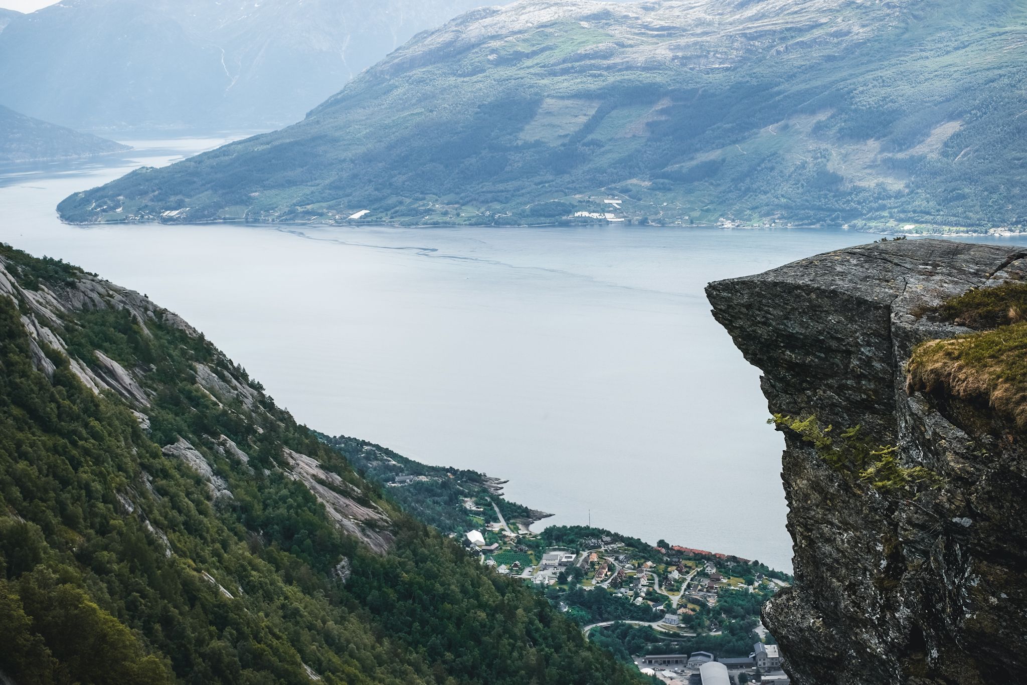 Cliff edge overlooking villages and fjord landscapes in Hardanger.