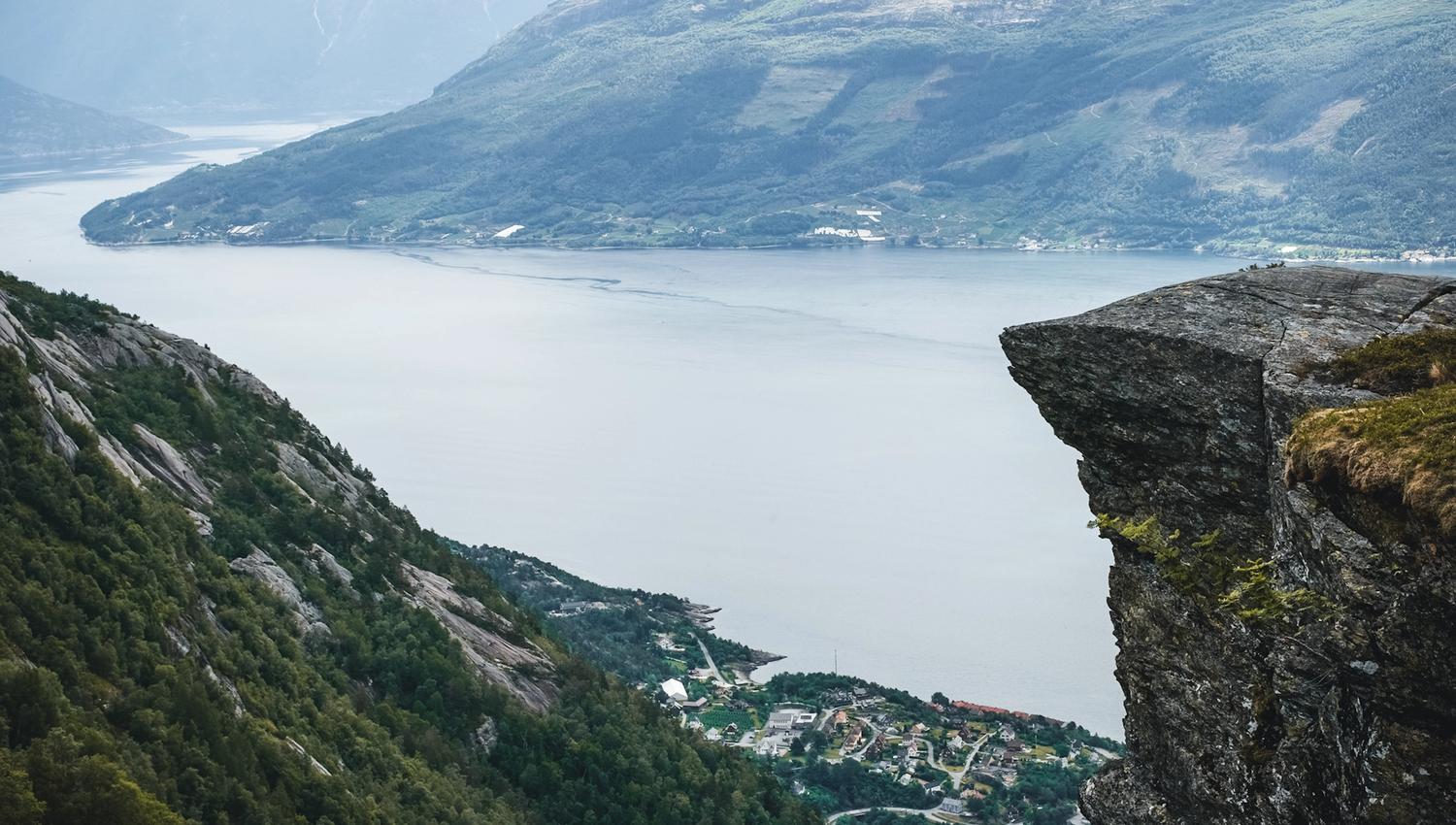 Cliff edge overlooking villages and fjord landscapes in Hardanger.