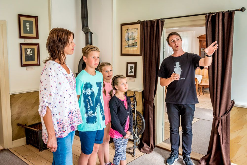 family on a tour of the Henrik Ibsen museum