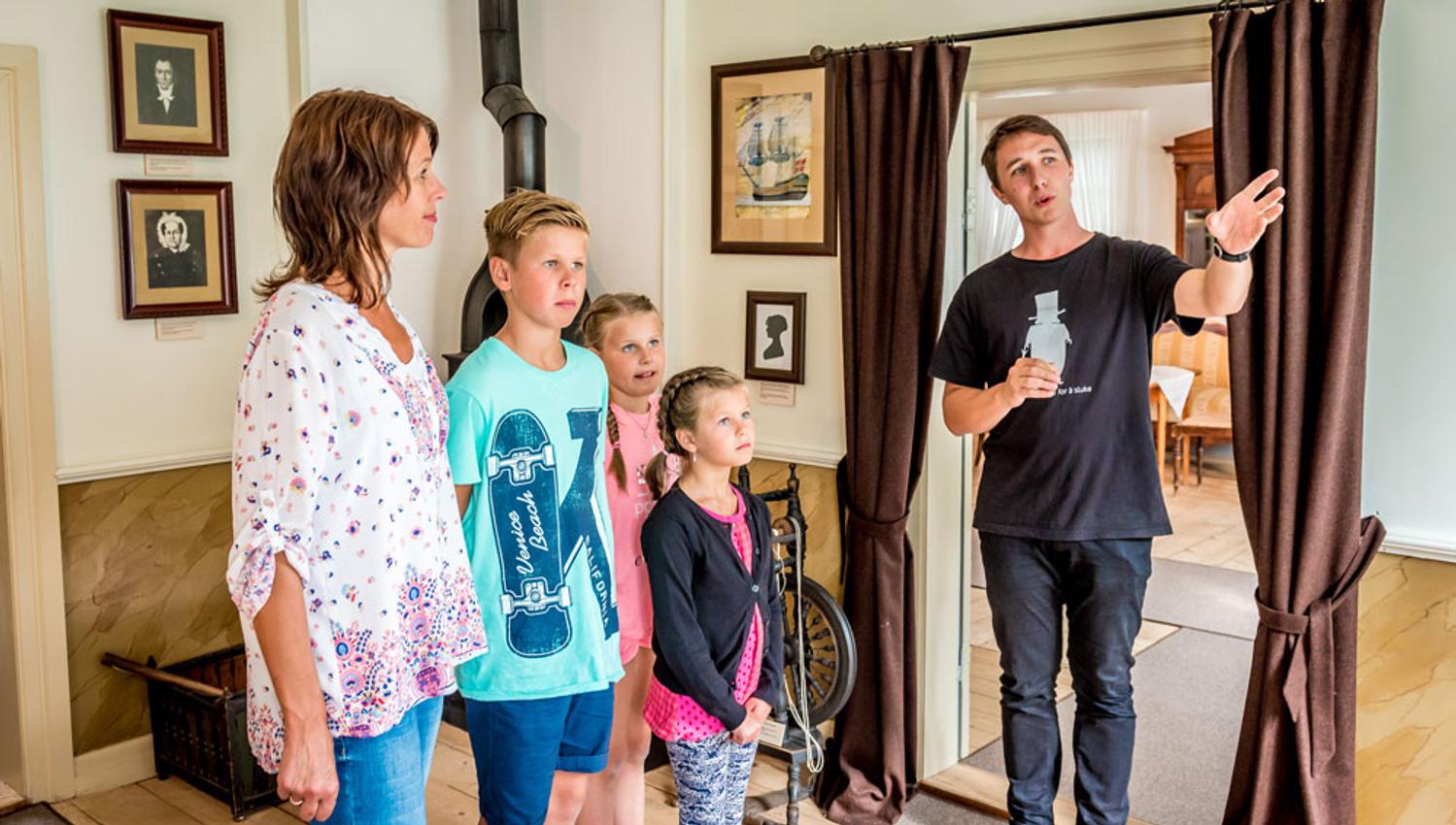 family on a tour of the Henrik Ibsen museum