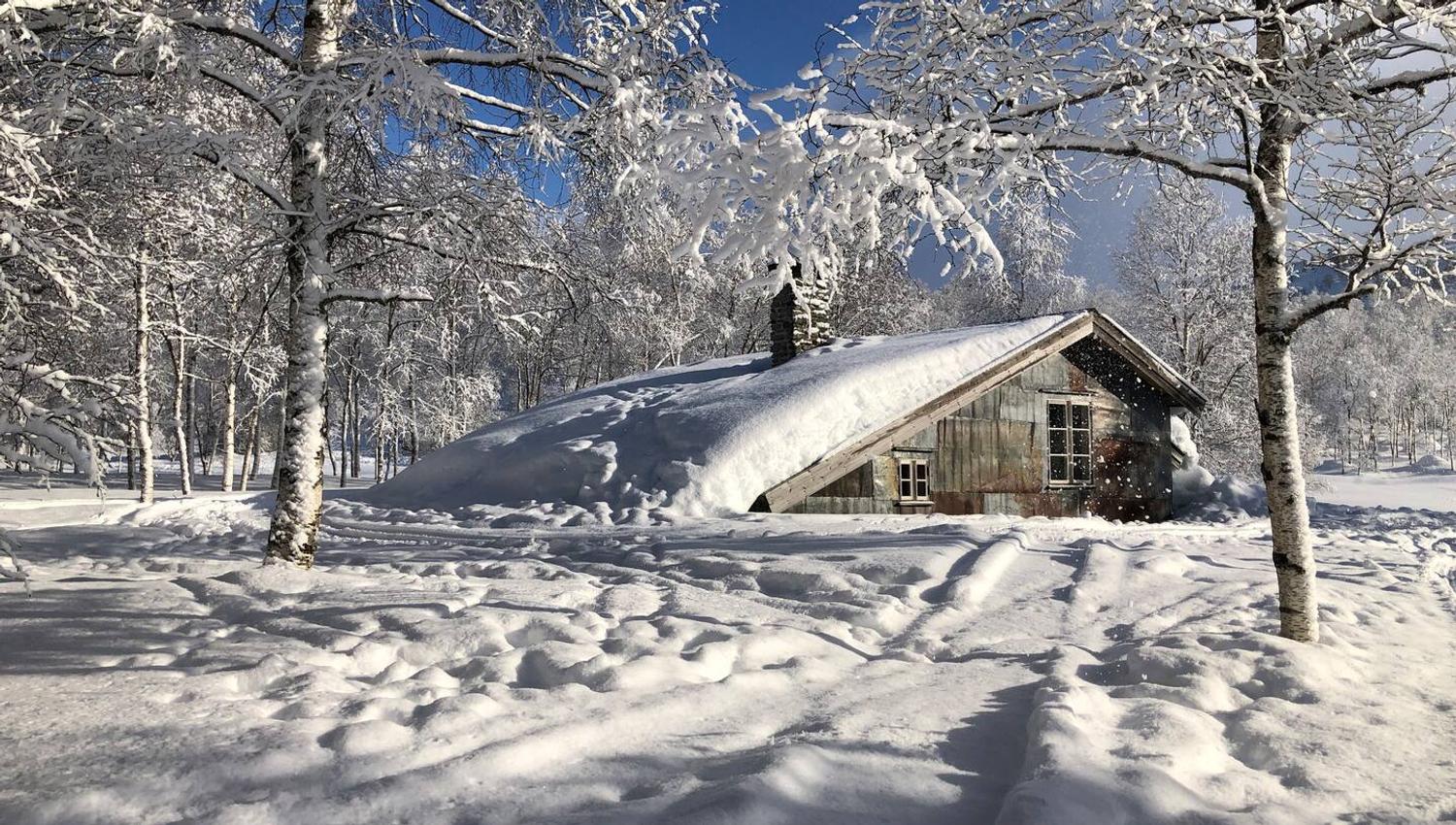 The cabin in a beautiful snowy landscape in winter