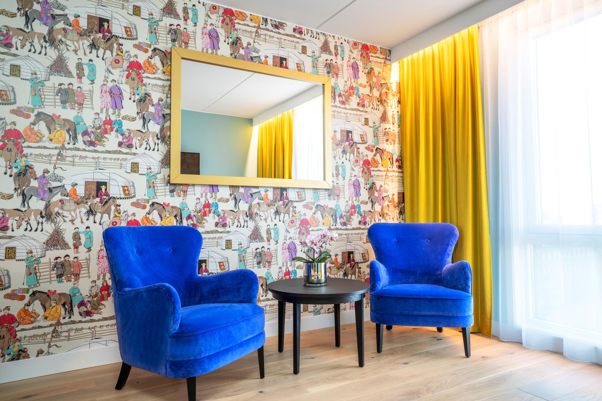 Two blue recliners, multi coloured wall. Thon Hotel Storo, Oslo. Photo
