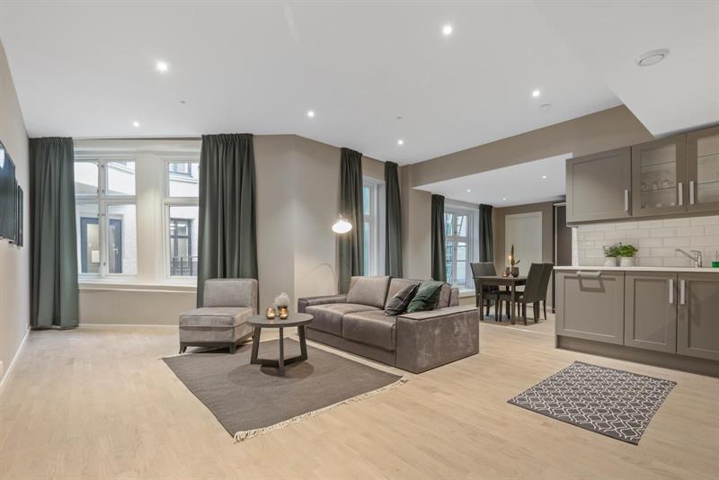 Open plan kitchen, dining and living room solution in one of the apartments