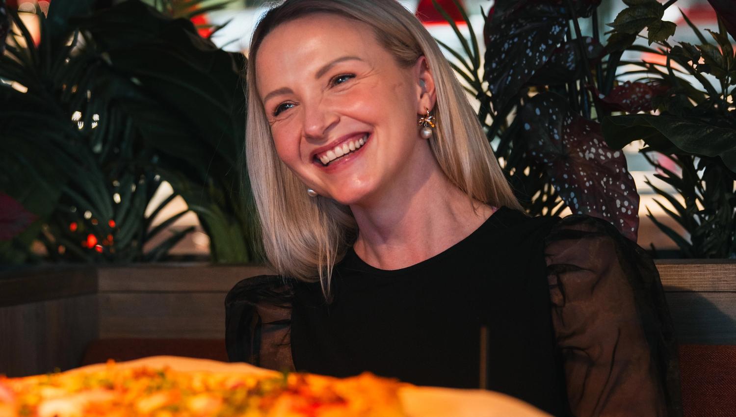 Peppes Pizza på Gjøvik. Blid jente spiser pizza.