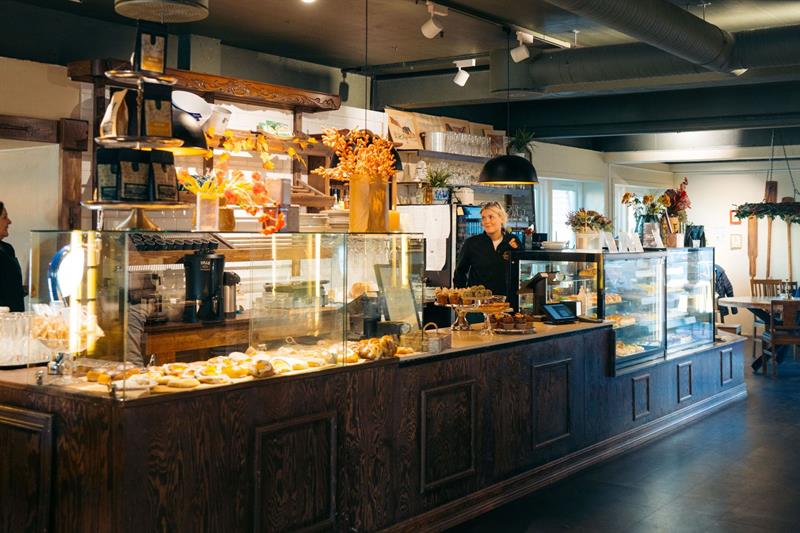 Interior of a café with an employee at the counter