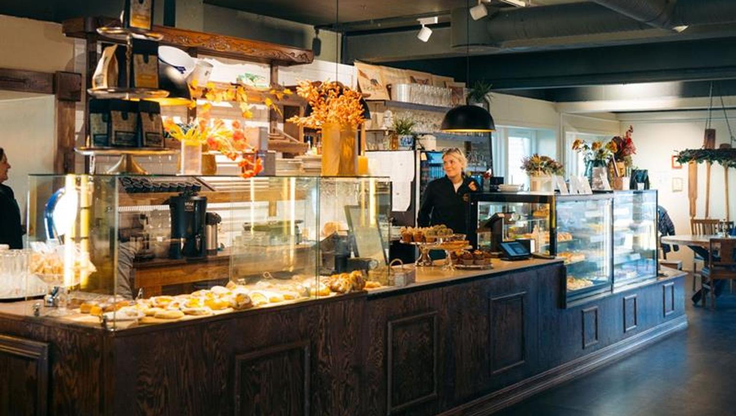 Interior of a café with an employee at the counter