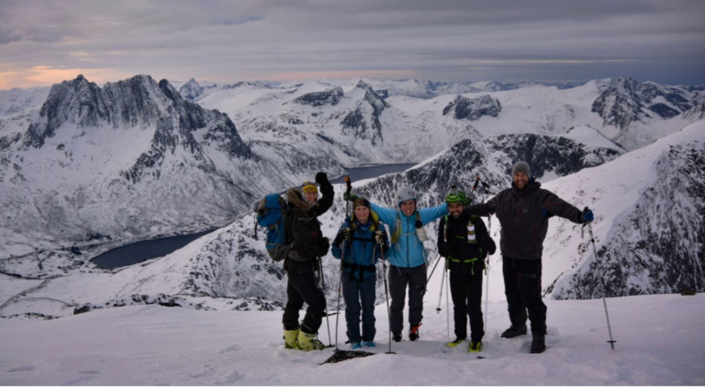 Guests posing on top of a mountain