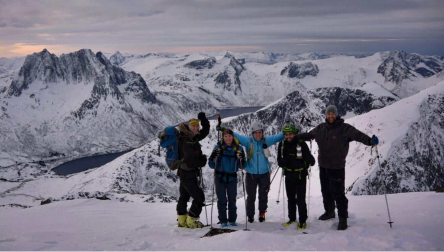 Guests posing on top of a mountain