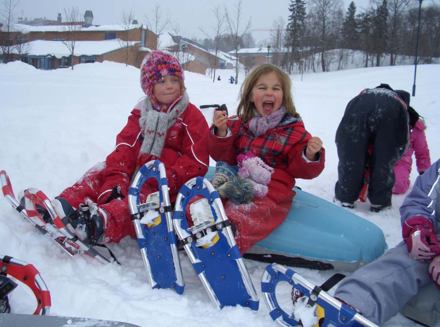 Girls with snowshoes taking a break