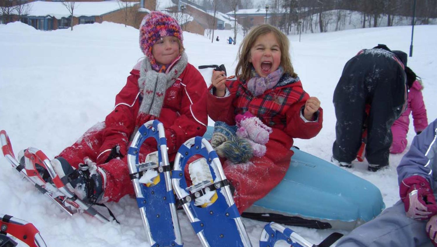 Girls with snowshoes taking a break