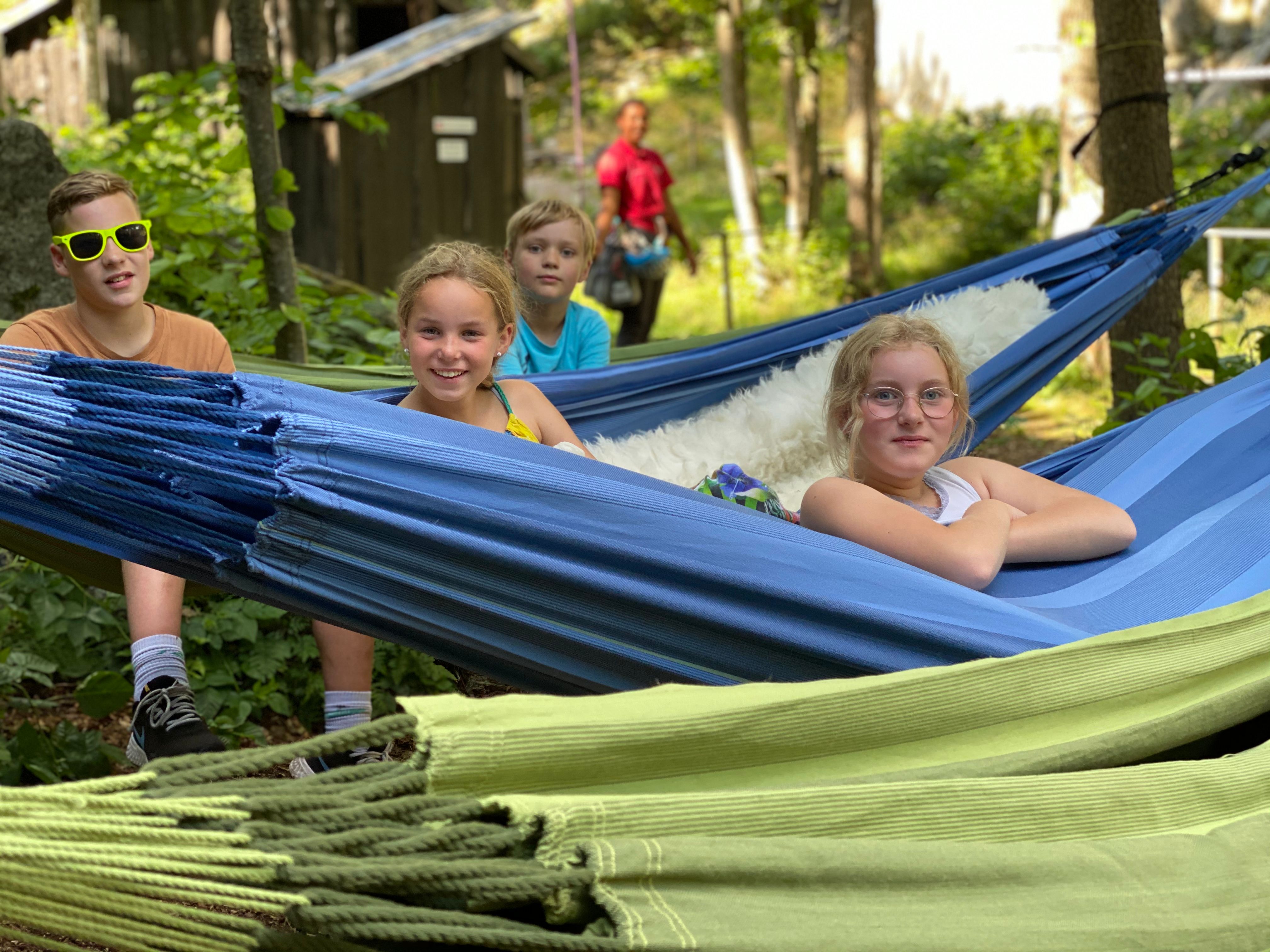 A family spends the night in hammocks