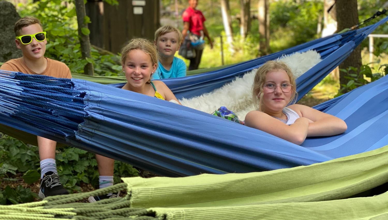 A family spends the night in hammocks