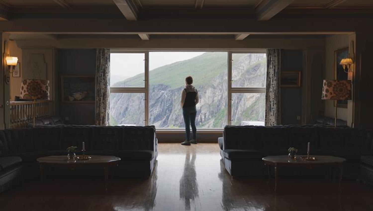 Silhouette of a woman enjoying the view towards the waterfall from one of the lounges.