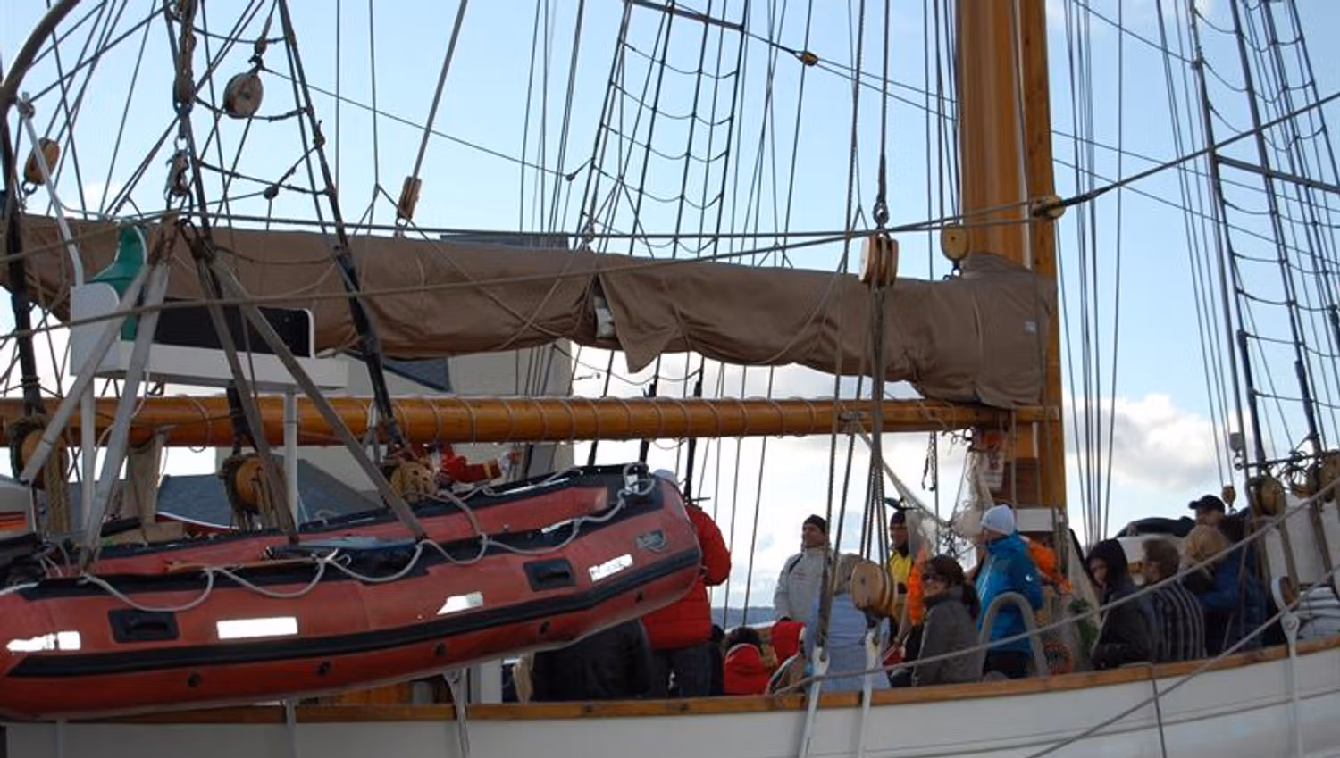 People standing on the deck of a wooden ship