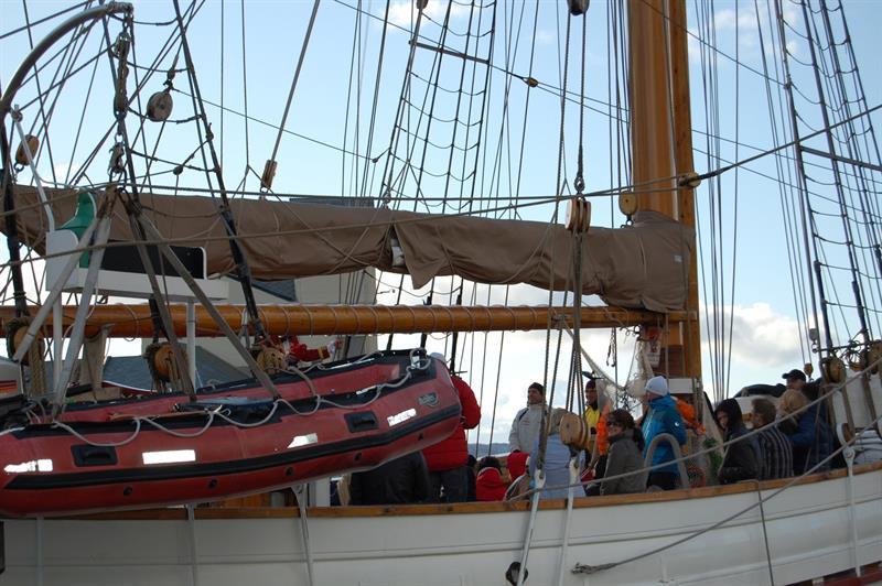 People standing on the deck of a wooden ship