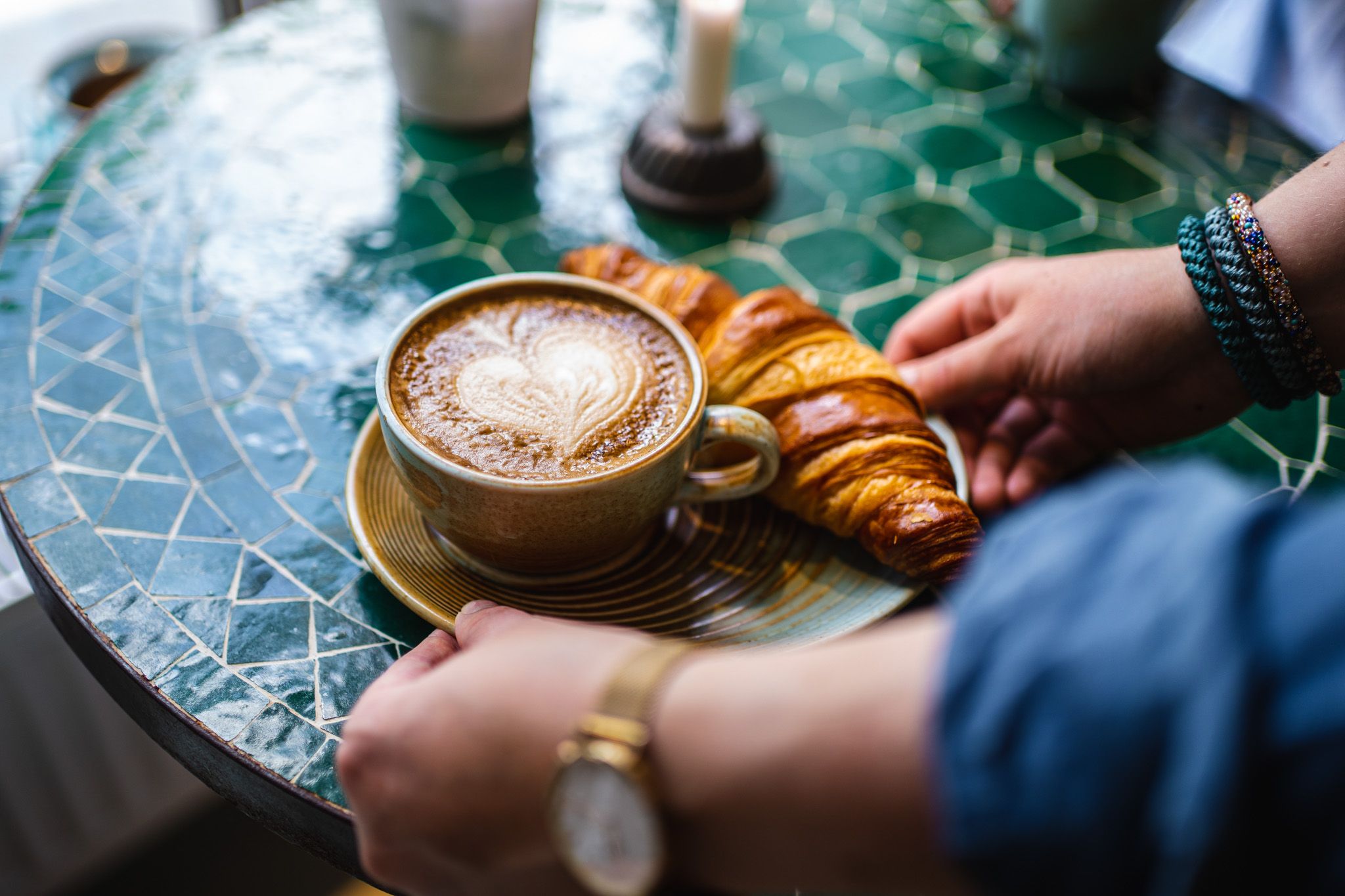 a tray with coffee and a croissant 