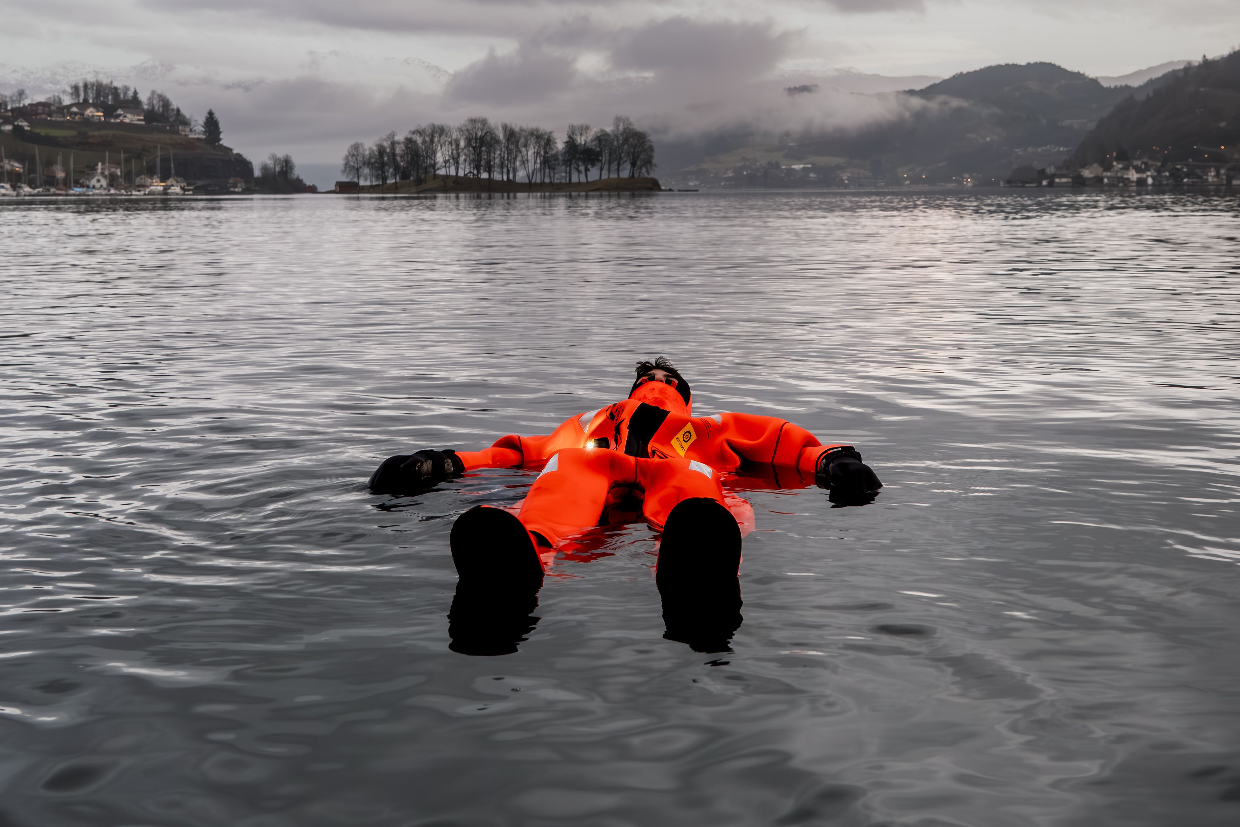 A person enjoy floating in the Hardangerfjord outside  Thon Hotel Sandven