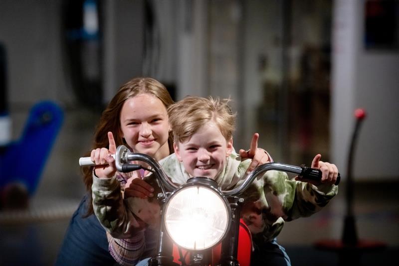 Two children sitting on a motorcycle