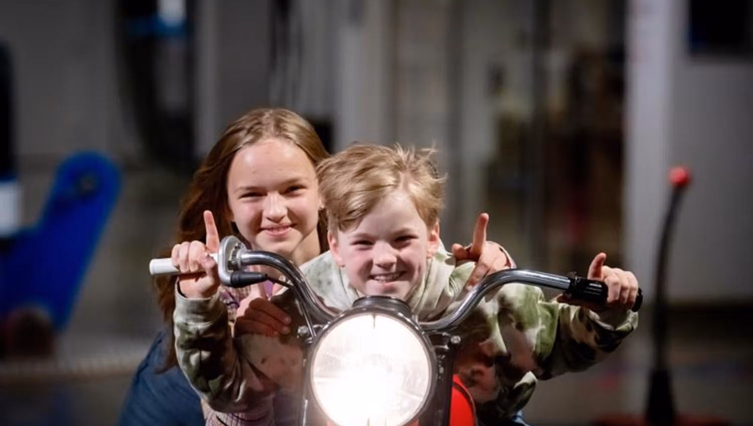 Two children sitting on a motorcycle