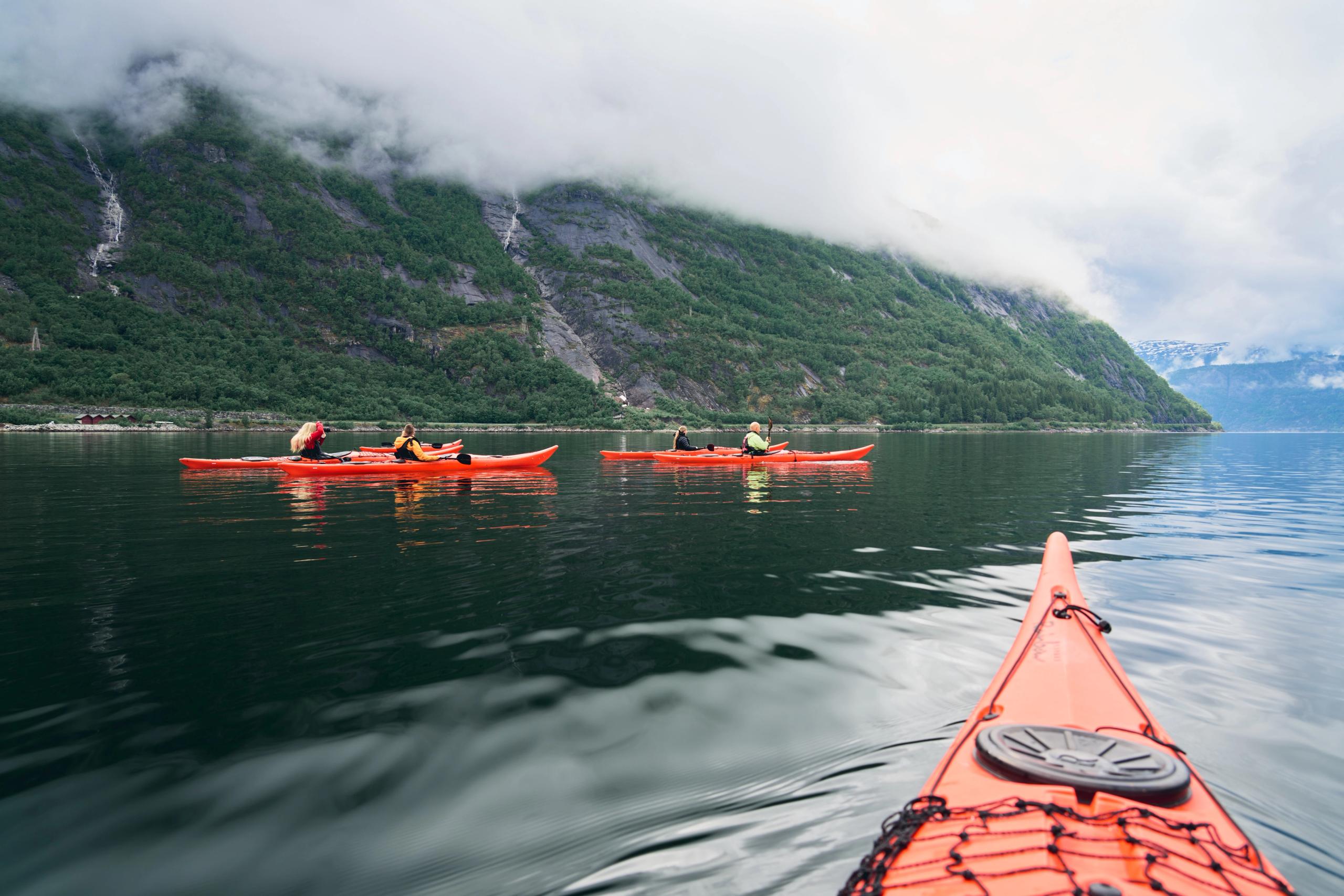 A few red kayaks on the fjord.