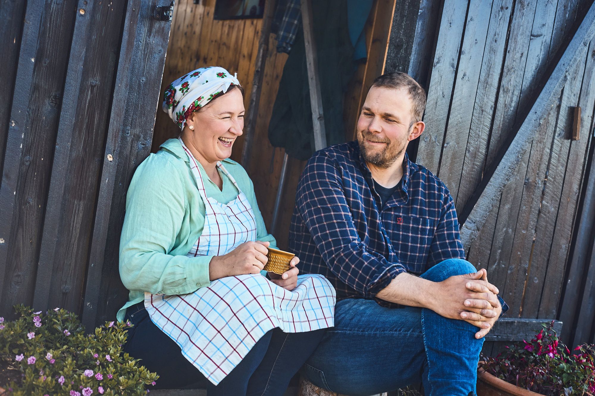 Two people enjoying coffee on the steps