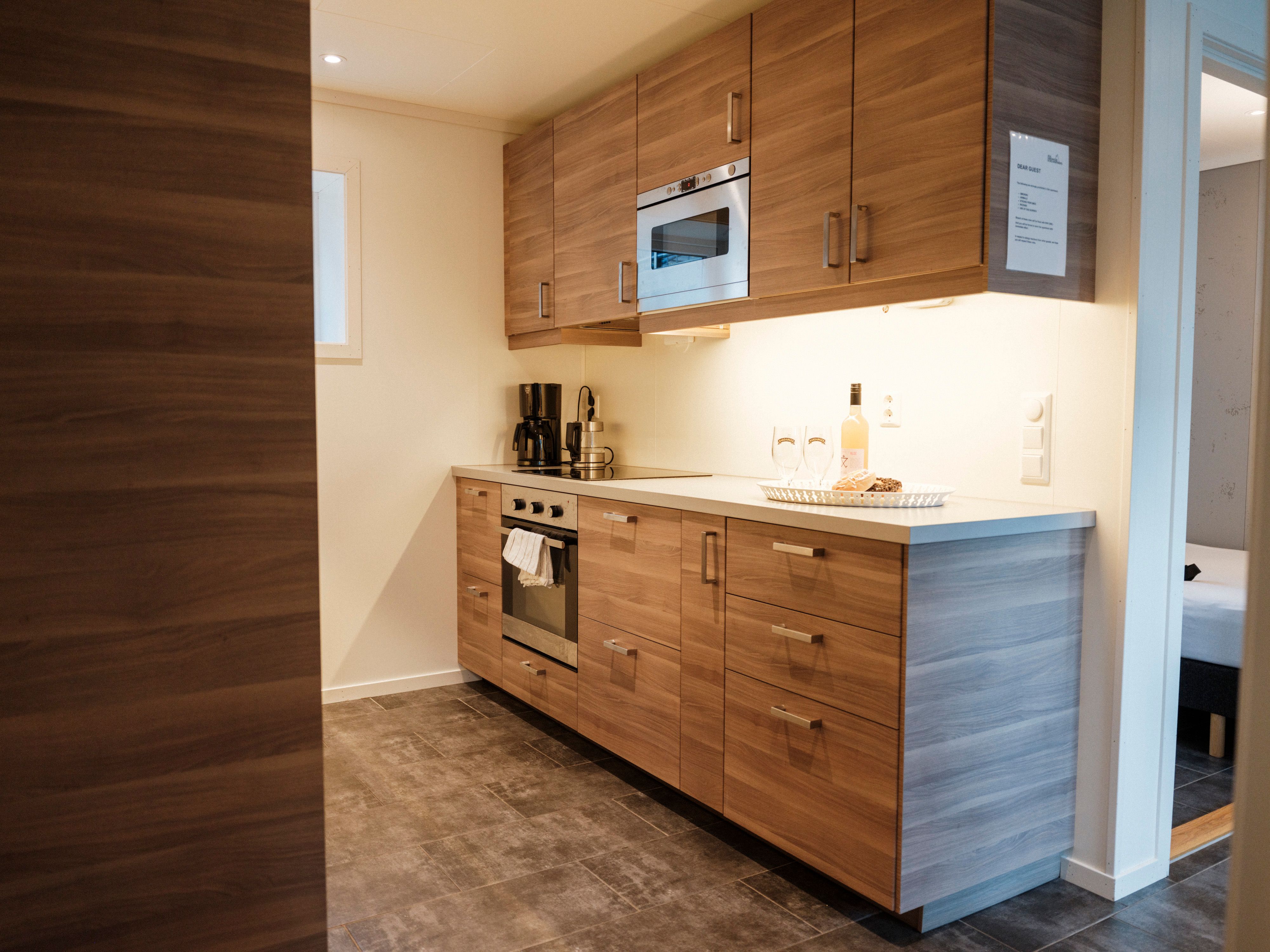 Aga Fjordapartments with green garden area and view of the Hardangerfjord.
