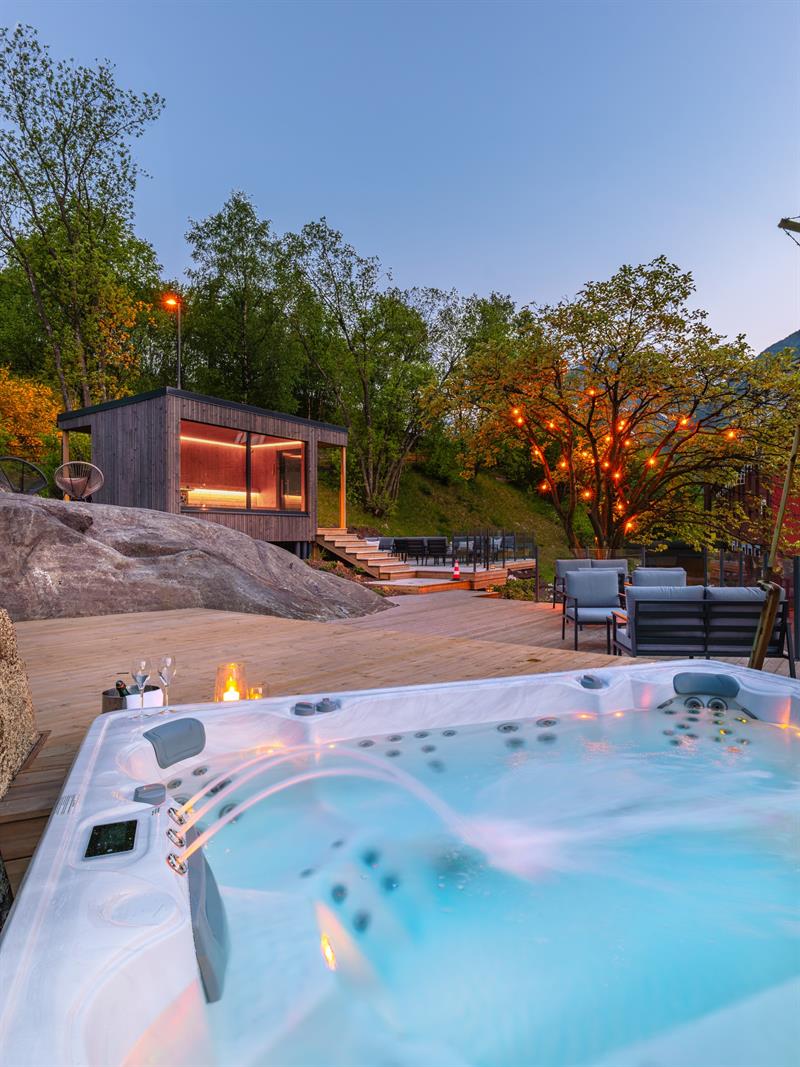Spa area with jacuzzi and outdoor terrace at Tyssedal Hotel during evening light.