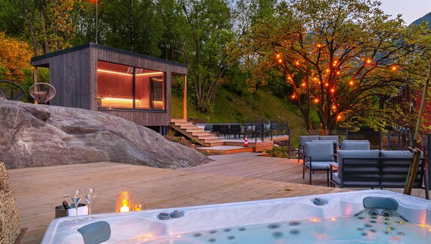 Spa area with jacuzzi and outdoor terrace at Tyssedal Hotel during evening light.