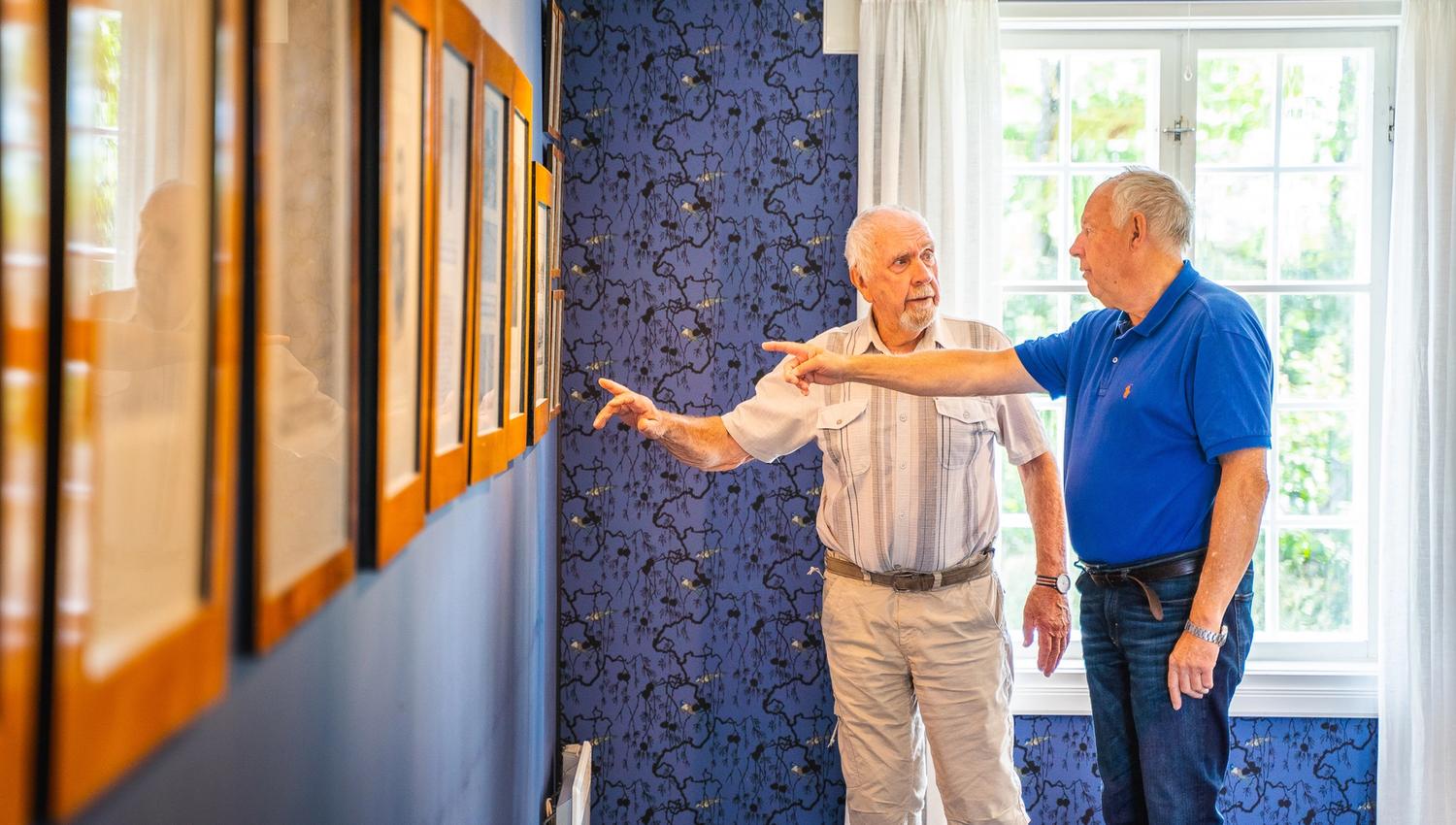 two menn looking at pictures