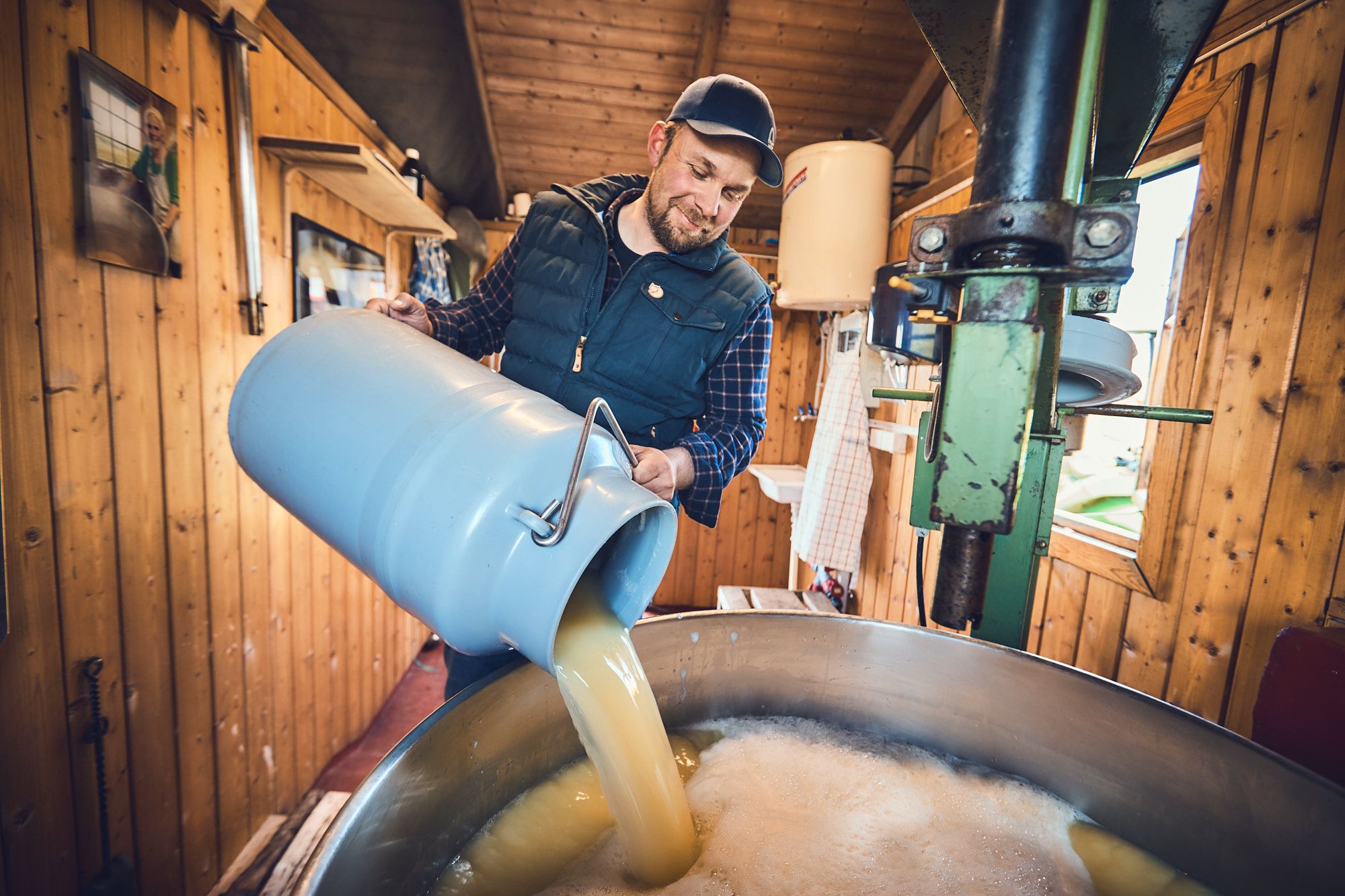 Man pouring milk in a giant pot