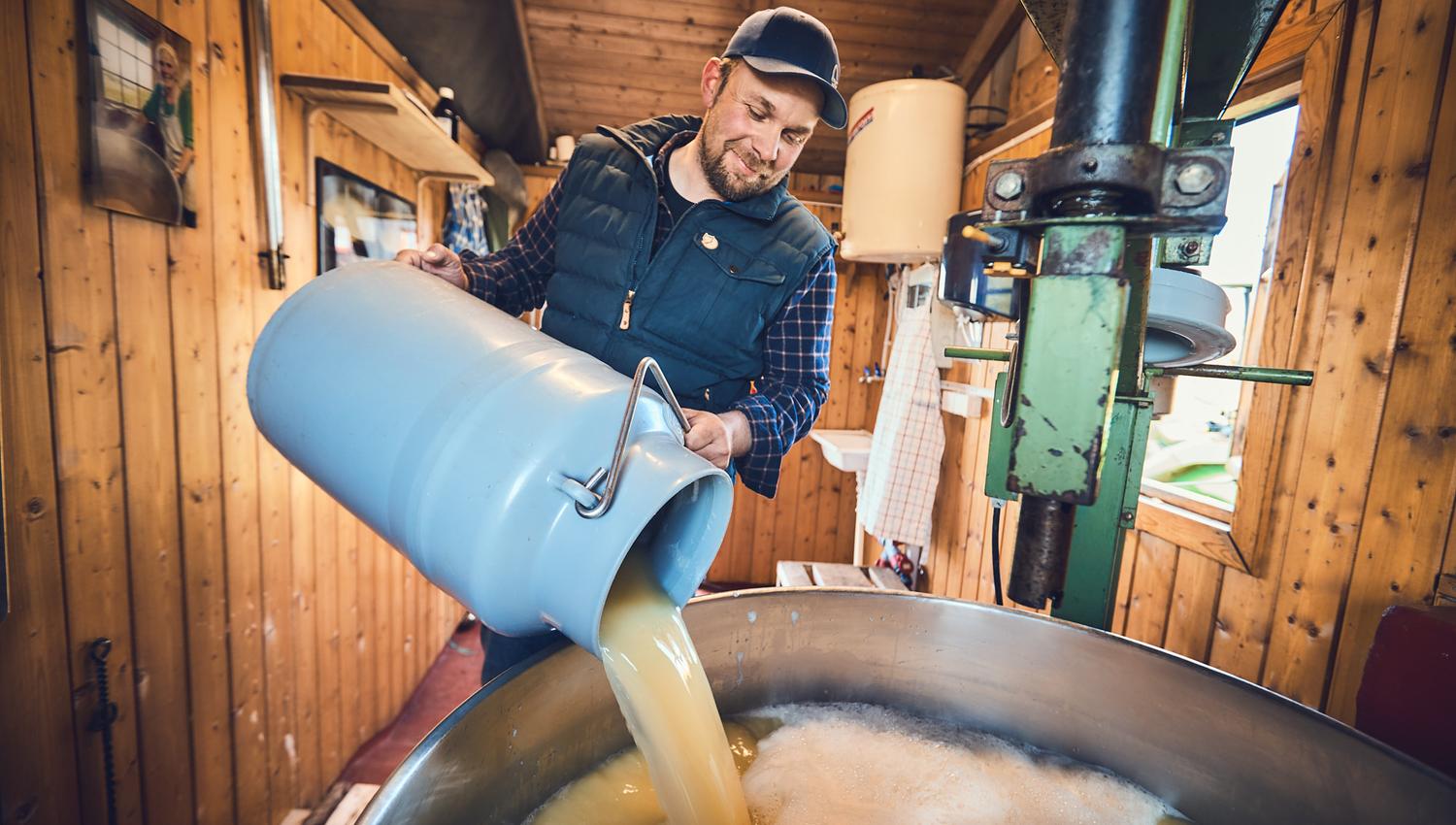 Man pouring milk in a giant pot