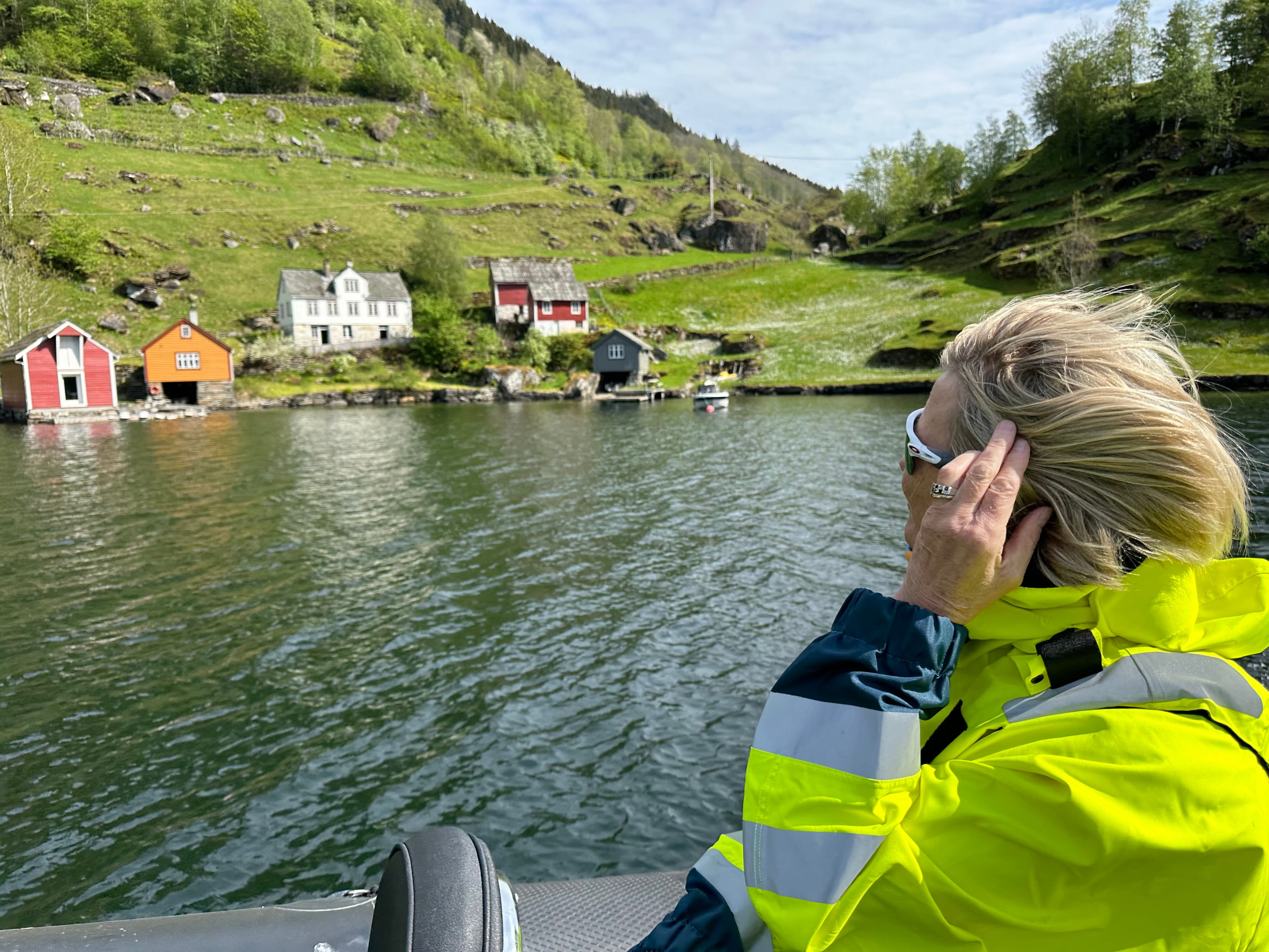 A view of small farms along the way on a fjord cruise in Rib boat on the Hardangerfjord