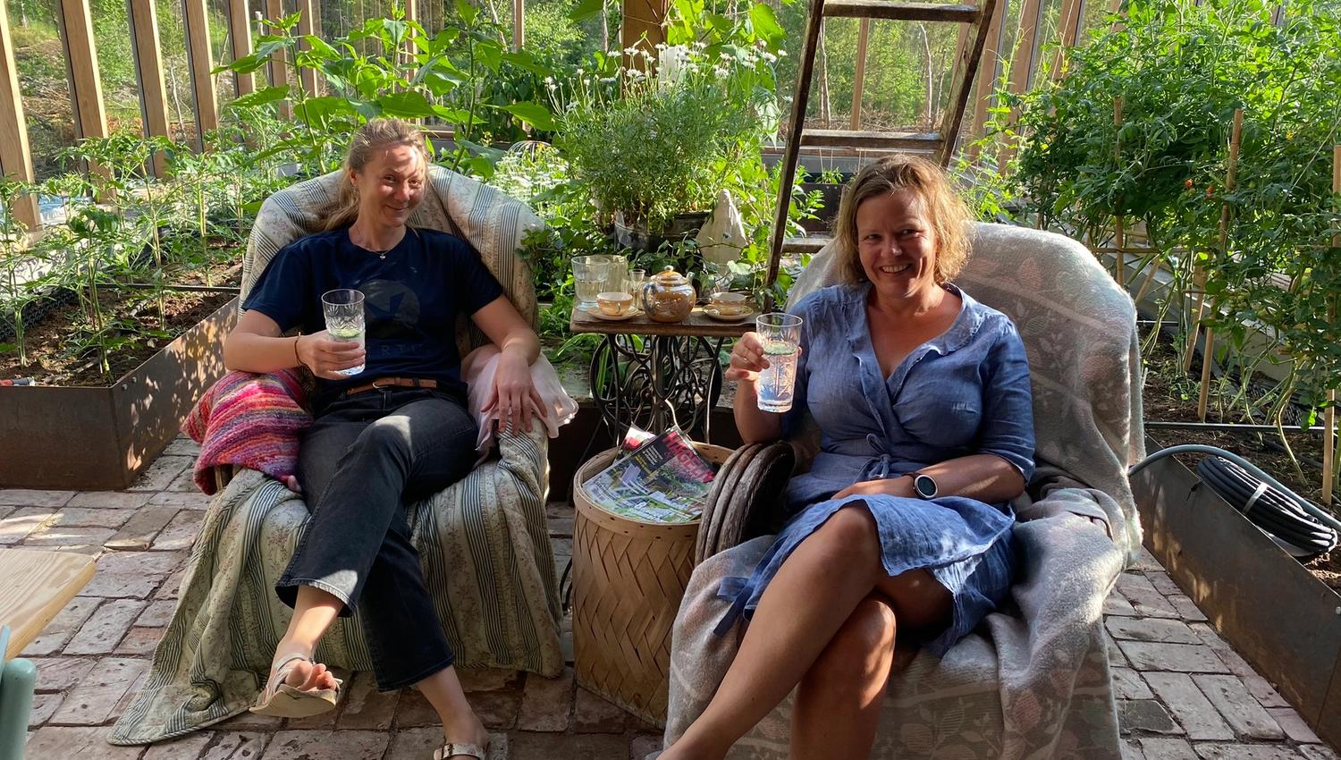 to women sitting together in a garden