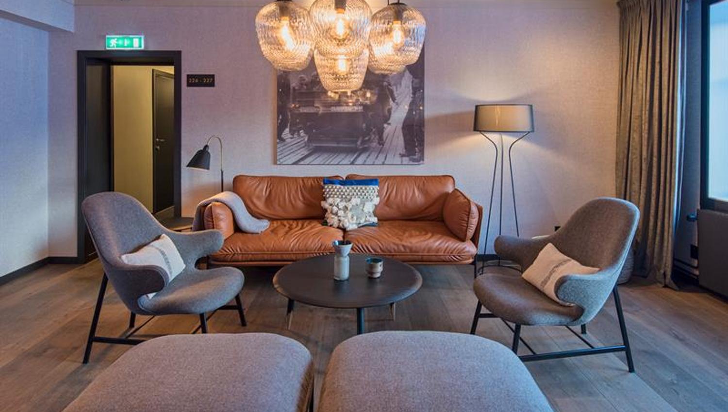 A sofa and chairs around a coffee table in a lounge