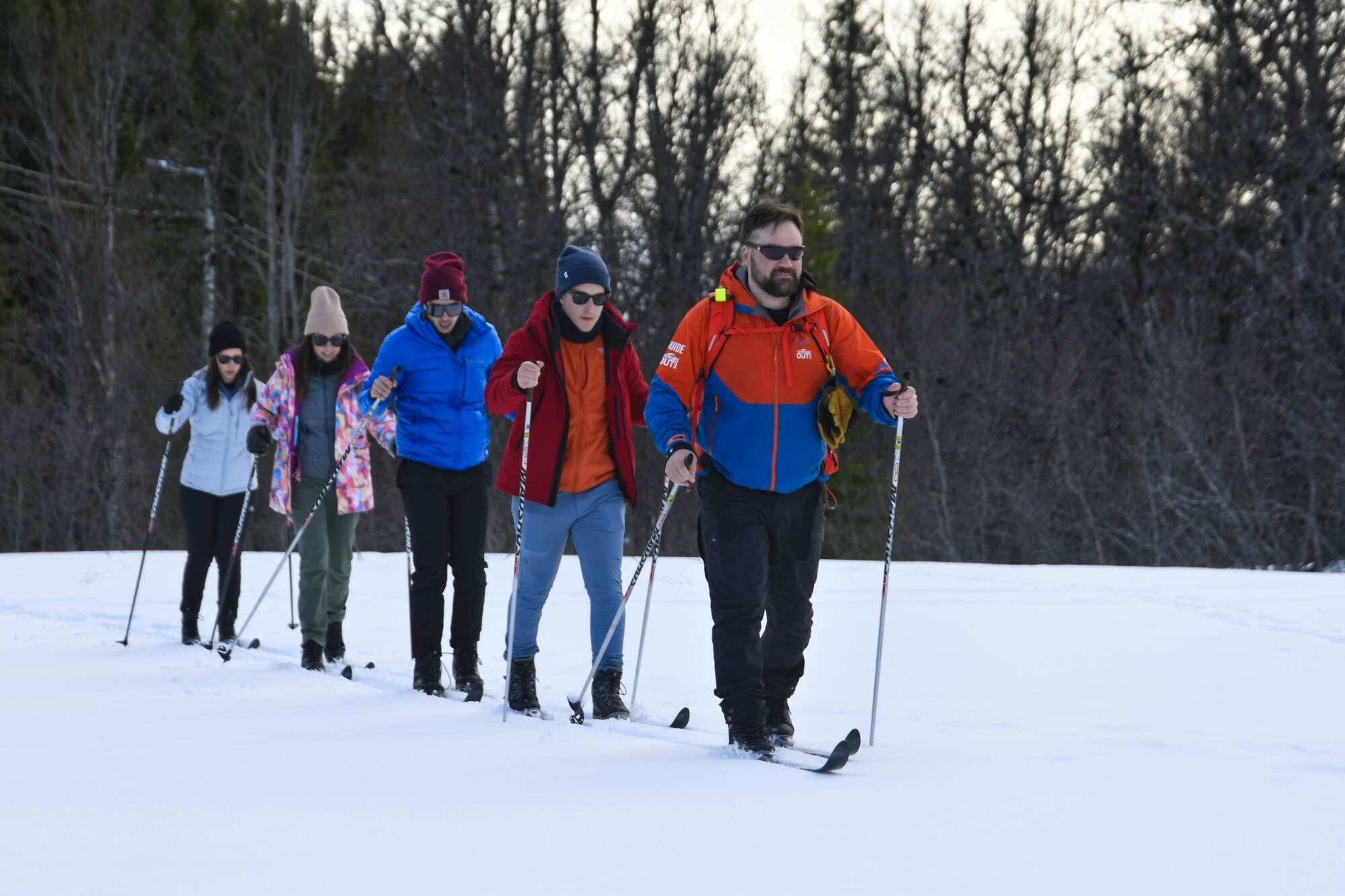 Guide leading the group on skis