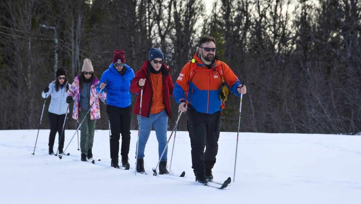 Guide leading the group on skis