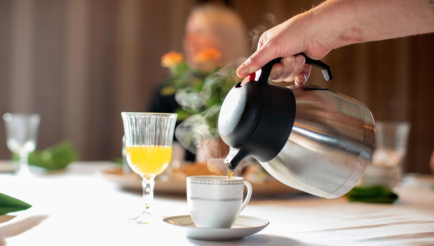 Coffee being poured into a coffee cup
