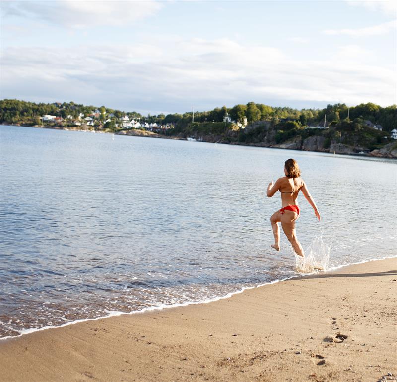 A girl running into the sea