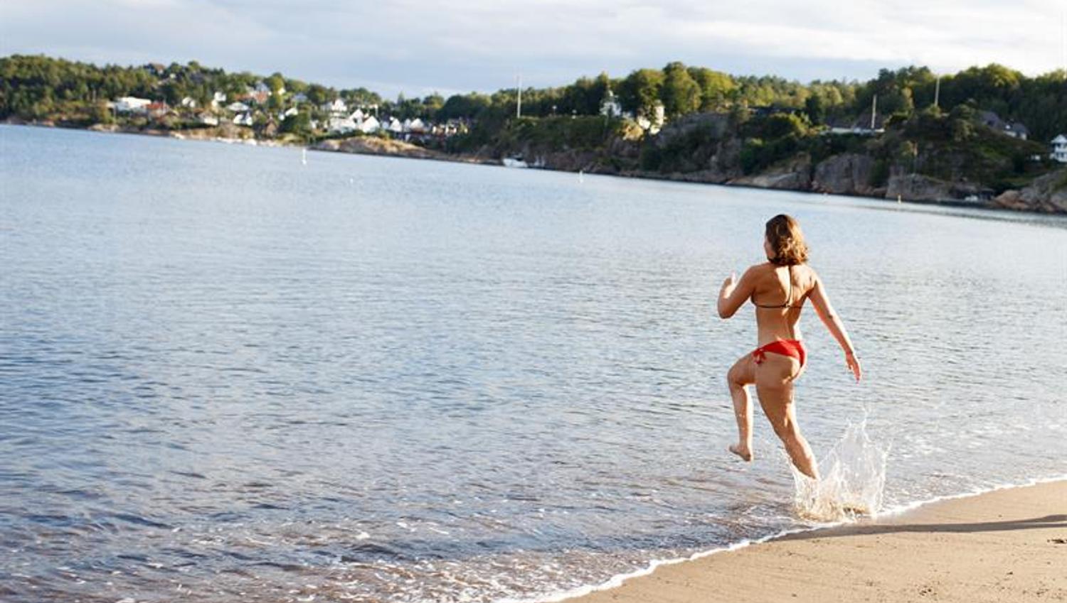 A girl running into the sea