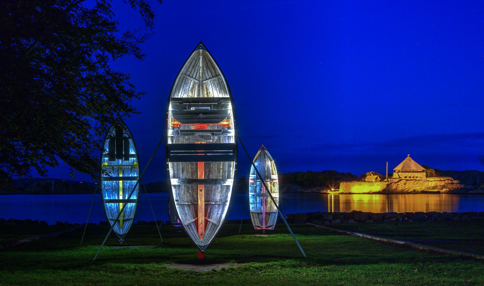 Old wooden boats are standing tall with lights inside
